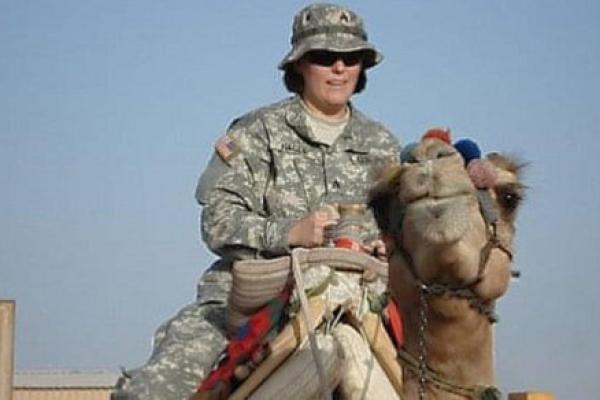 Elizabeth Nagle, a licensed practical nurse at Penn State Health Medical Group, Community Practice Division, rides a camel in Kuwait during Operation Iraqi Freedom, where she provided medical support to the Oklahoma National Guard during deployment to Iraq.