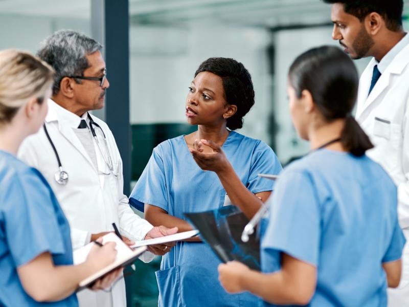 Health care workers gather for a discussion.